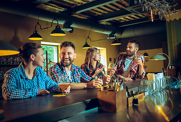 Image showing Sport, people, leisure, friendship and entertainment concept - happy football fans or male friends drinking beer and celebrating victory at bar or pub