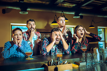 Image showing Sport, people, leisure, friendship and entertainment concept - happy football fans or male friends drinking beer and celebrating victory at bar or pub