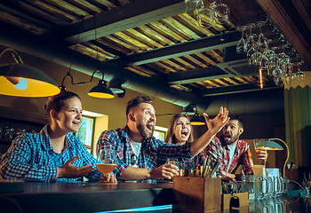 Image showing Sport, people, leisure, friendship and entertainment concept - happy football fans or male friends drinking beer and celebrating victory at bar or pub