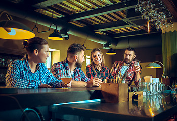 Image showing Sport, people, leisure, friendship and entertainment concept - happy football fans or male friends drinking beer and celebrating victory at bar or pub