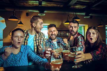 Image showing Sport, people, leisure, friendship and entertainment concept - happy football fans or male friends drinking beer and celebrating victory at bar or pub