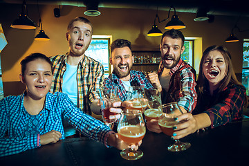 Image showing Sport, people, leisure, friendship and entertainment concept - happy football fans or male friends drinking beer and celebrating victory at bar or pub