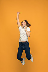 Image showing Full length of pretty young woman with mobile phone while jumping