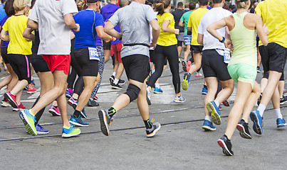 Image showing Marathon runners running race people feet on city road 