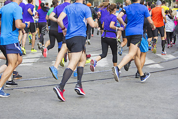 Image showing Marathon runners running race people feet on city road 