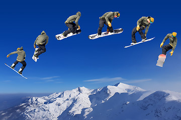 Image showing Snowboarding Snowboard Snowboarder at jump mountains at sunny da