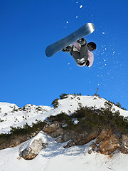 Image showing Snowboarding Snowboard Snowboarder at jump mountains at sunny da