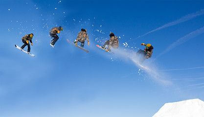 Image showing Snowboarding Snowboard Snowboarder at jump mountains at sunny da