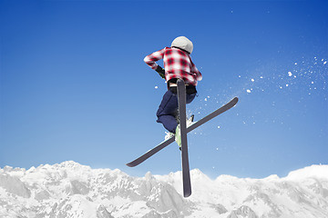 Image showing Flying skier at jump inhigh on snowy mountains