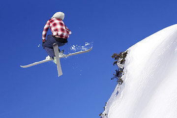 Image showing Flying skier at jump inhigh on snowy mountains