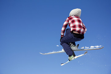 Image showing Flying skier at jump inhigh on snowy mountains