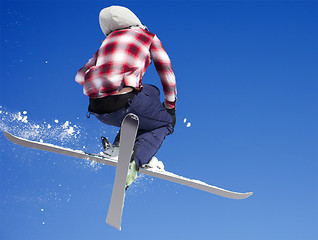 Image showing Flying skier at jump inhigh on snowy mountains