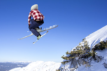 Image showing Flying skier at jump inhigh on snowy mountains