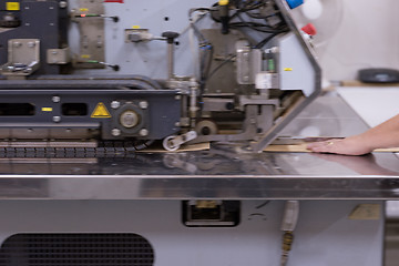 Image showing engineer in front of wood cutting machine