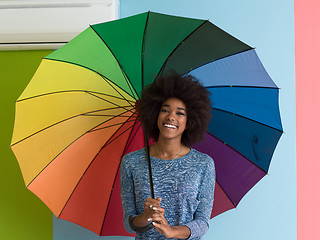 Image showing young black woman holding a colorful umbrella