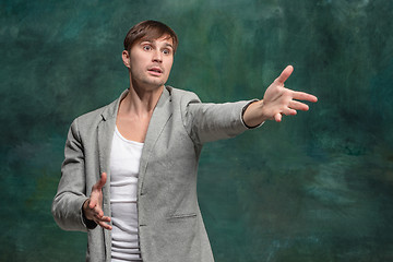 Image showing Isolated on pink young casual man shouting at studio