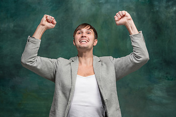 Image showing Winning success man happy ecstatic celebrating being a winner. Dynamic energetic image of male model