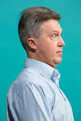 Image showing The senior attractive man looking suprised isolated on blue