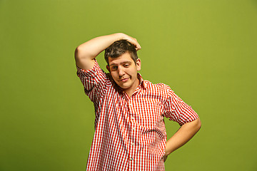 Image showing Beautiful bored man isolated on green background