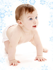 Image showing crawling baby boy looking up