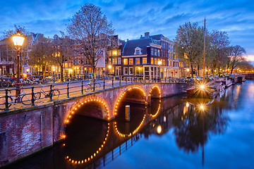 Image showing Amterdam canal, bridge and medieval houses in the evening