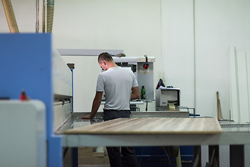 Image showing worker in a factory of wooden furniture