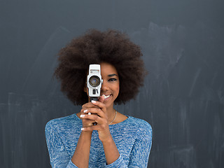 Image showing african american woman using a retro video camera