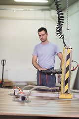 Image showing worker in a factory of wooden furniture