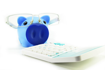 Image showing Piggy bank with eye glasses and calculator