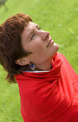 Image showing redhead woman sitting on the grass