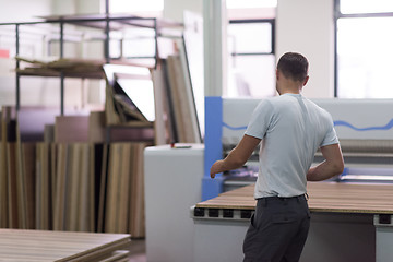 Image showing worker in a factory of wooden furniture