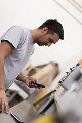 Image showing engineer in front of wood cutting machine