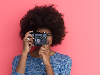 Image showing young black girl taking photo on a retro camera