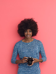 Image showing young black girl taking photo on a retro camera