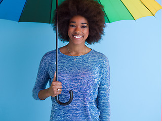 Image showing beautiful black woman holding a colorful umbrella