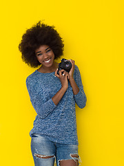 Image showing young african american girl taking photo on a retro camera