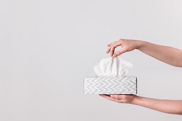 Image showing Delicate female hands holding a tissue box