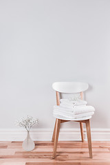 Image showing White towels on a chair in a bright interior