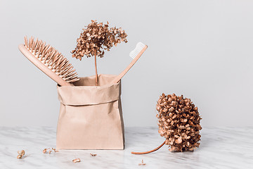 Image showing Hairbrush, toothbrush and gardenias