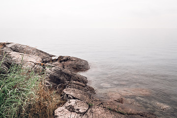 Image showing Rocky coast and smooth water