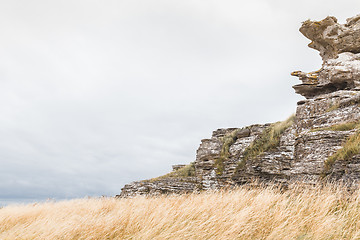 Image showing Limestone cliff and grass field