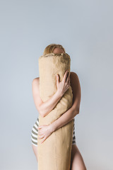 Image showing Girl hugging a body pillow