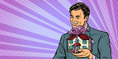 Image showing Businessman selling real estate, house as a gift