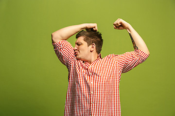 Image showing Handsome young man showing biceps expressing strength and gym concept,