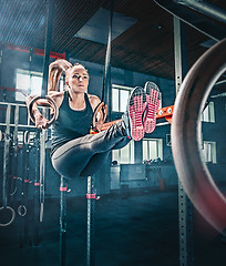 Image showing Concept: power, strength, healthy lifestyle, sport. Powerful attractive muscular woman at CrossFit gym