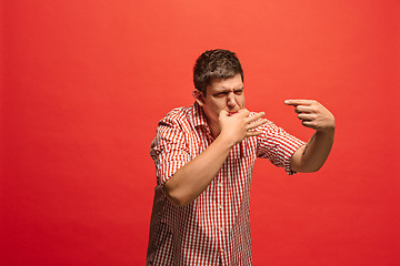 Image showing Isolated on green young casual man shouting at studio