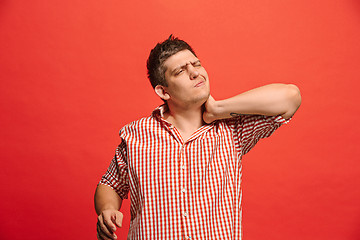 Image showing Man having headache. Isolated over red background.