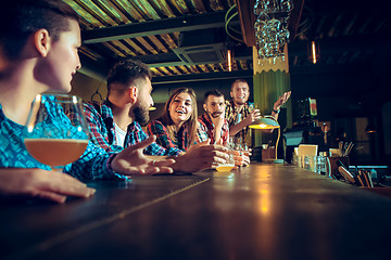 Image showing Sport, people, leisure, friendship and entertainment concept - happy football fans or male friends drinking beer and celebrating victory at bar or pub