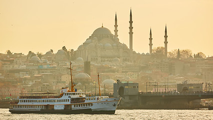 Image showing Tourist boat sails on the Golden Horn in Istanbul at sunset, Turkey.