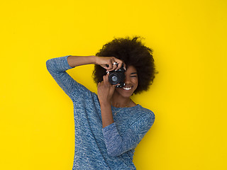 Image showing young african american girl taking photo on a retro camera